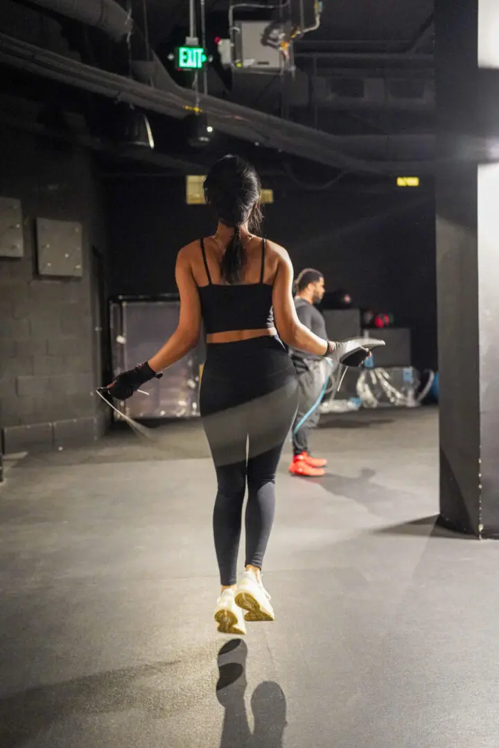 A woman skipping at the gym with a rope