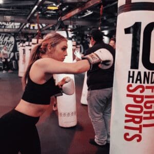 A woman punching a punching bag
