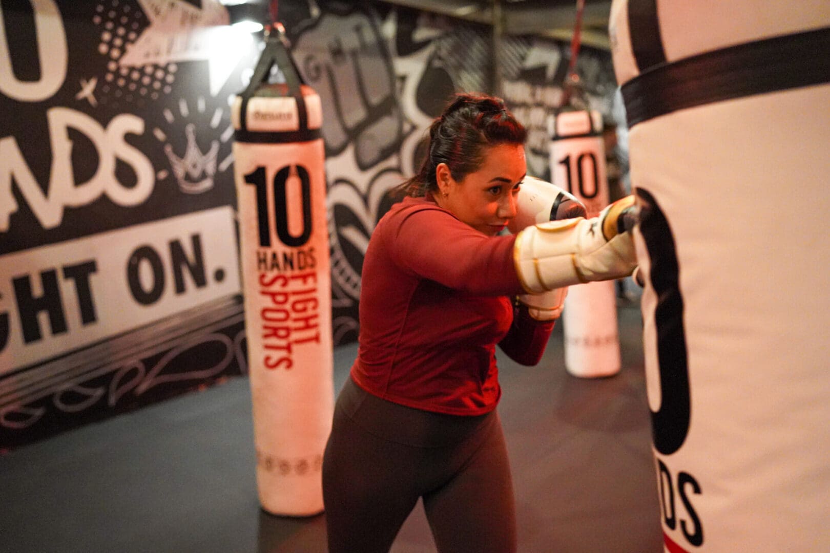 A woman is boxing in the gym